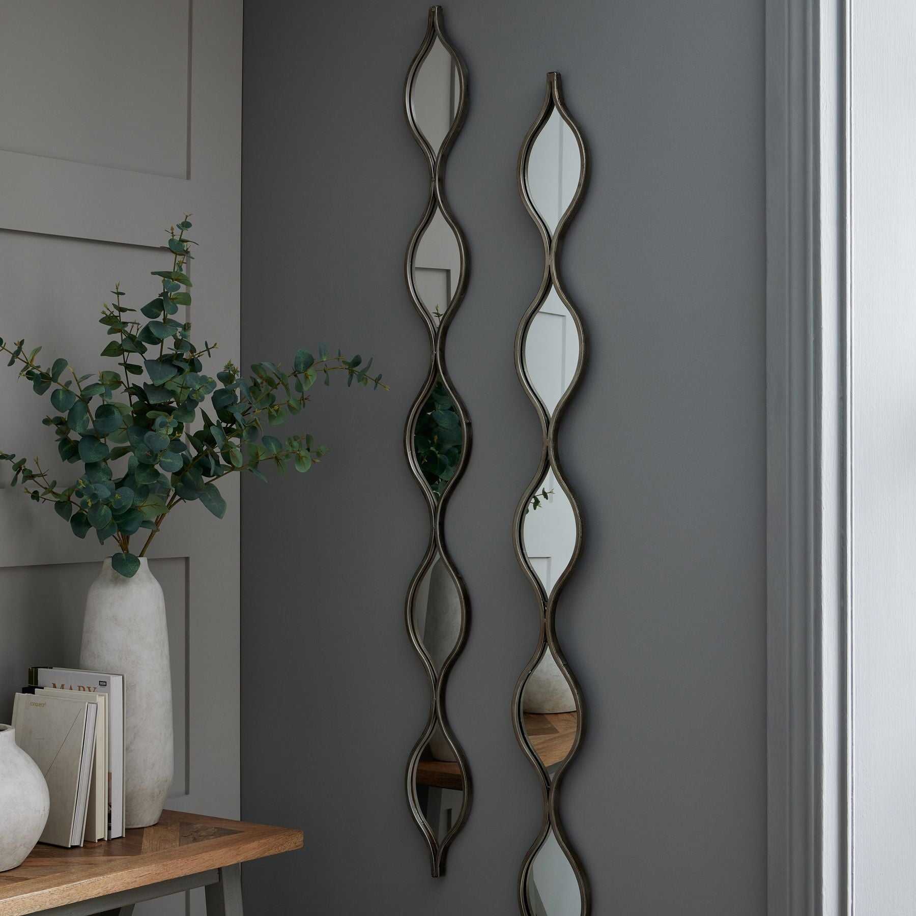 Aries Silver Mirror with sleek frame and lustrous finish, reflecting refined style and elegance in a versatile decor setting.