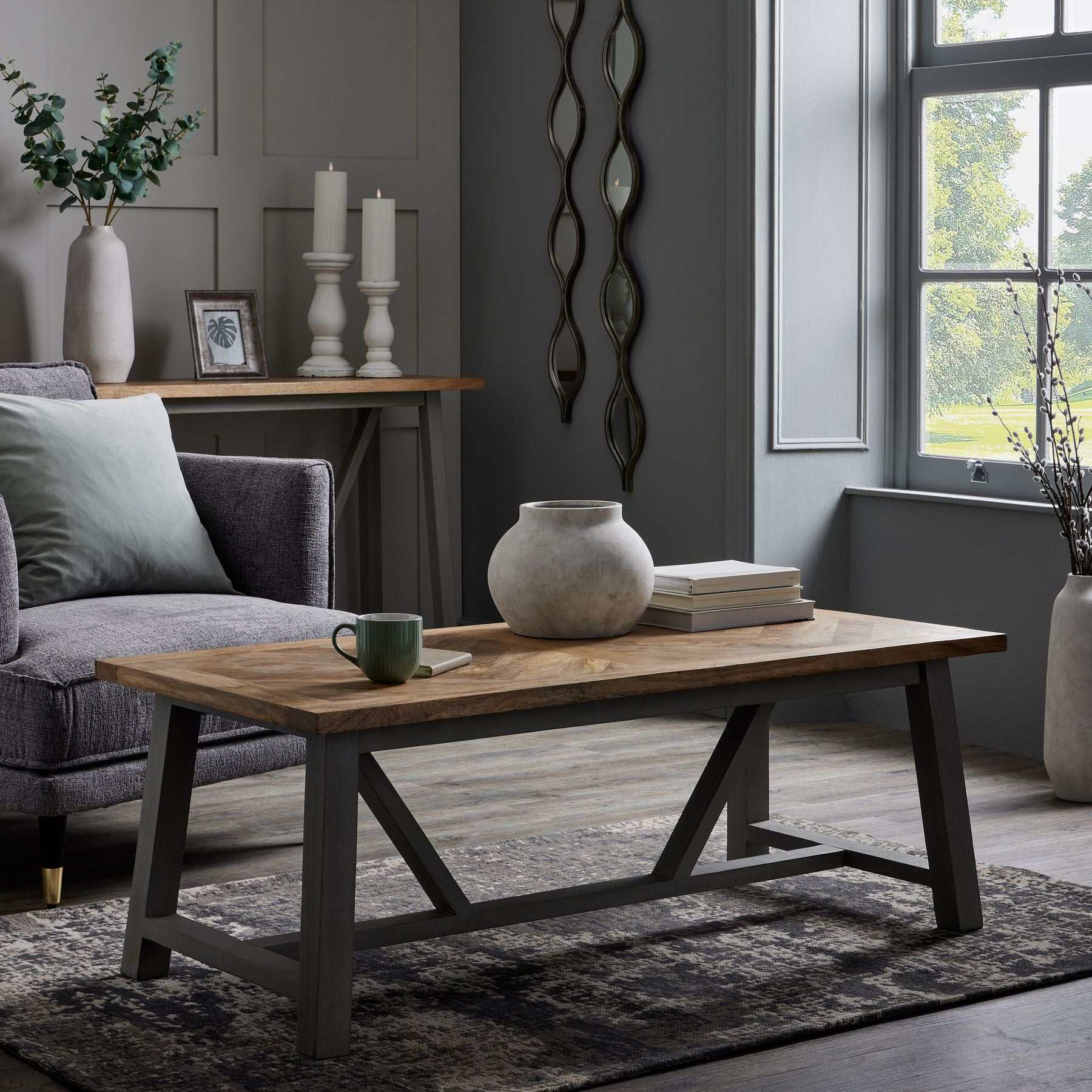 Aries Silver Mirror with sleek frame and lustrous finish in elegant living room setting.