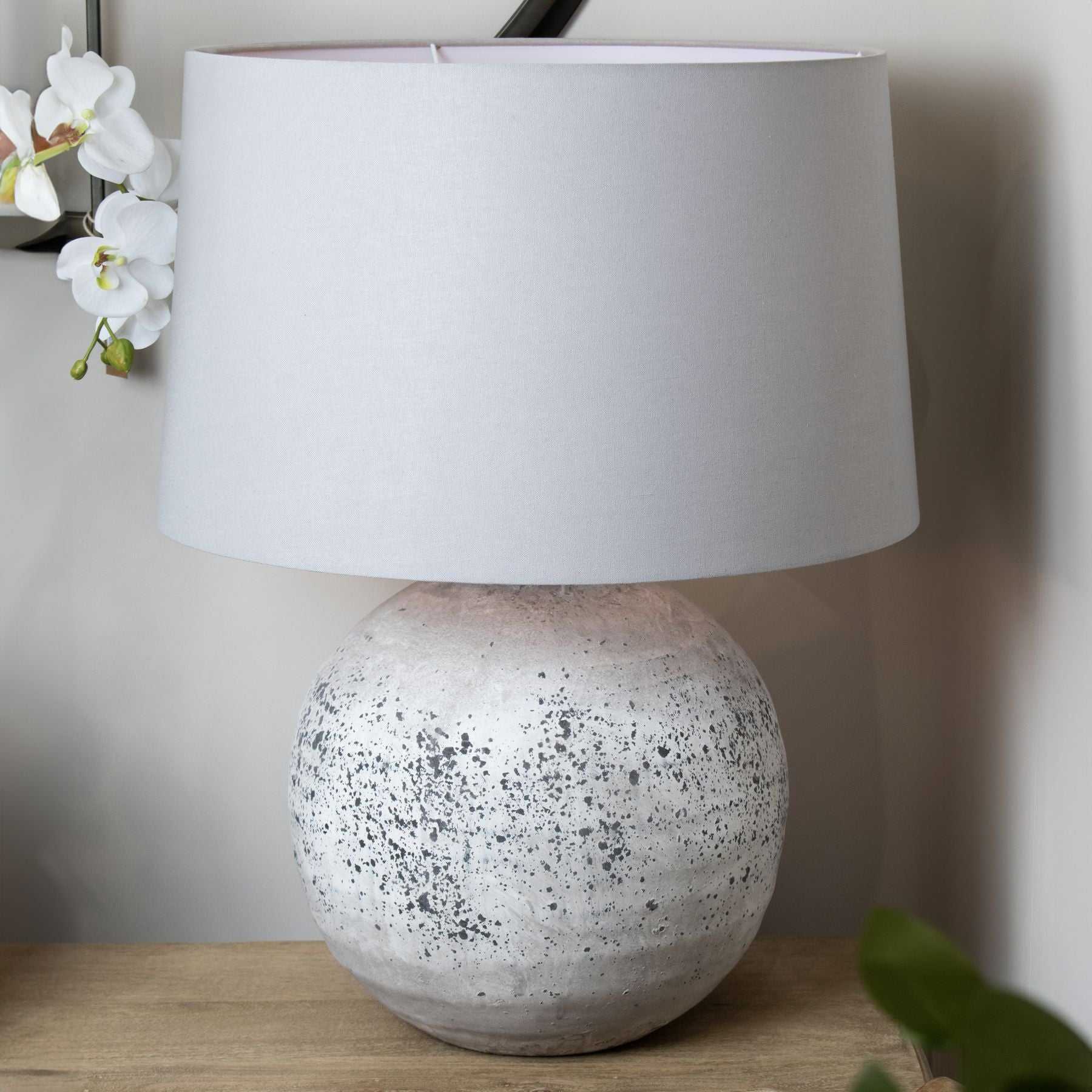 Vieana ceramic lamp with stone effect base and grey fabric shade.