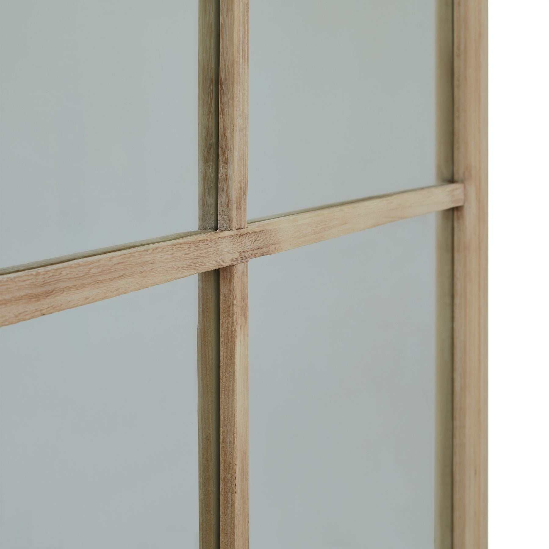 Betty oversized window mirror with weathered wood detailing and grid pattern.