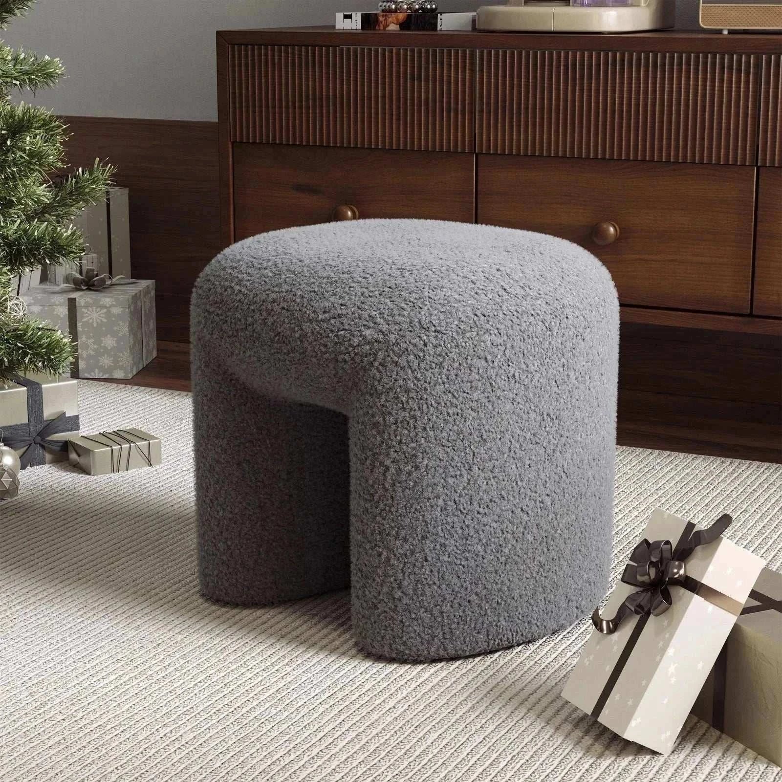 Theadra stool in grey teddy bear fur upholstery placed in a cozy living room setting.