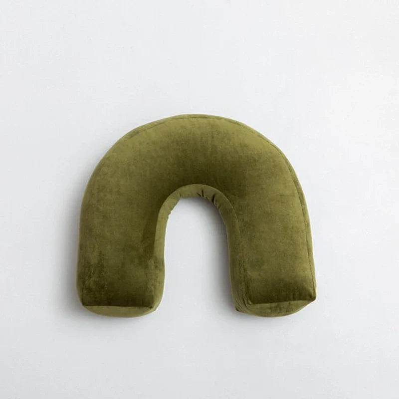 Cyril Cushions playful green pillow with unique waves and knot design.