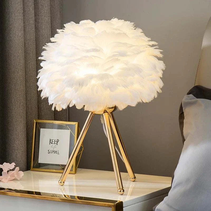 Elegant Feather Table Lamp with delicate feather design on a tripod base, creating a warm glow and cozy ambiance on a modern table.