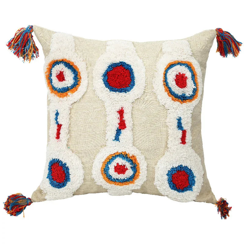 Moroccon style pillow case with intricate patterns and colorful tassels.