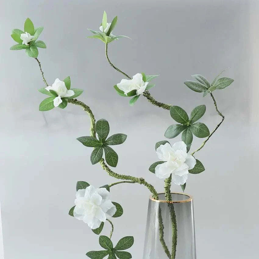 Faux Azaleas Branch in a clear vase, adding elegance and freshness to home decor.