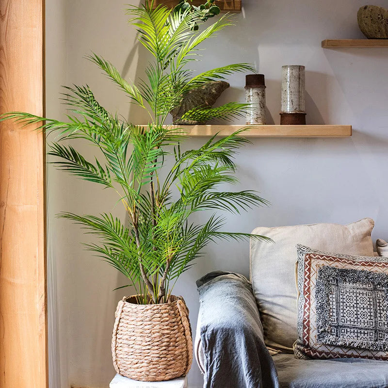 Faux Palm Tree Branch in woven pot enhancing home decor with tropical flair.