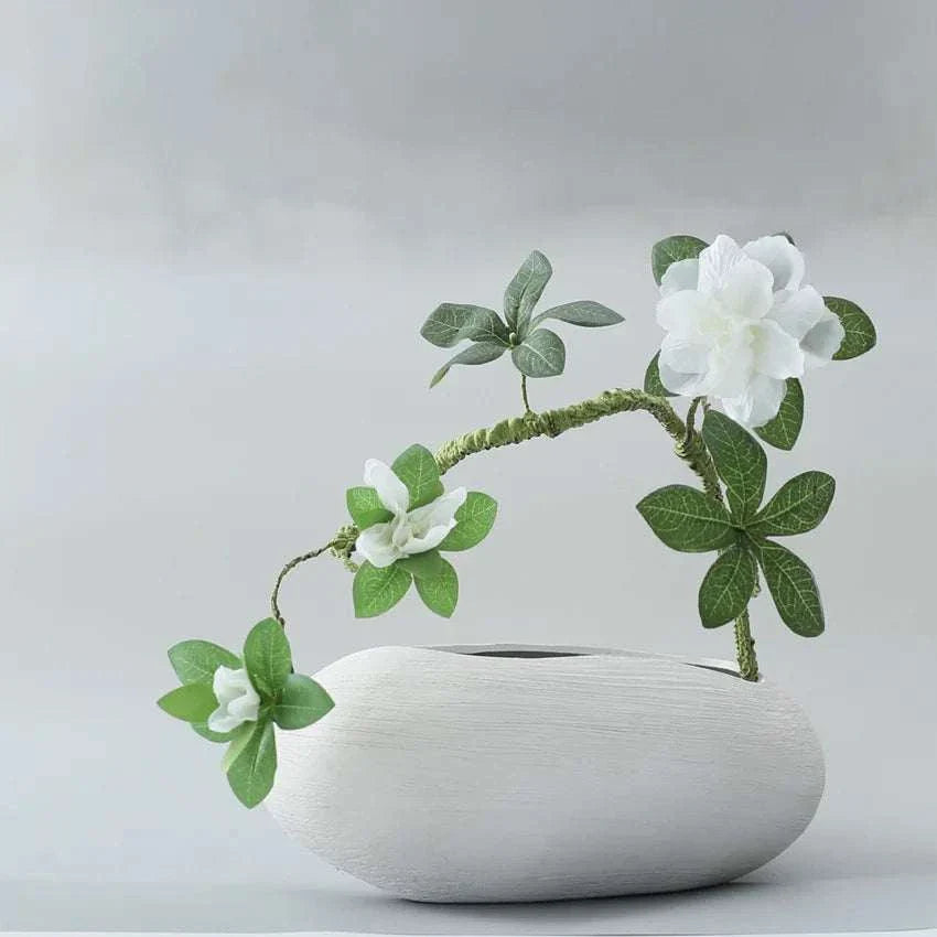 Faux Azaleas Branch in elegant white vase adding natural elegance to home decor.