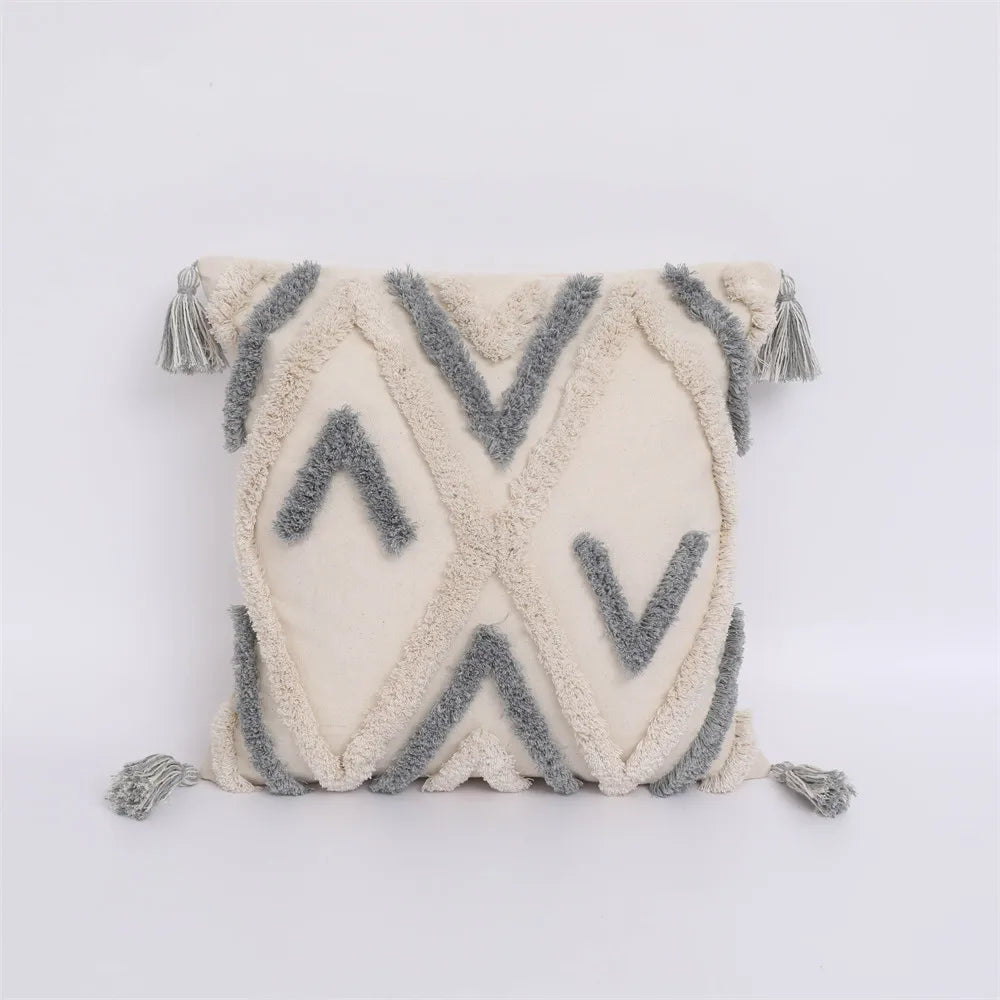 Moroccan style pillow case with intricate patterns and tassels.
