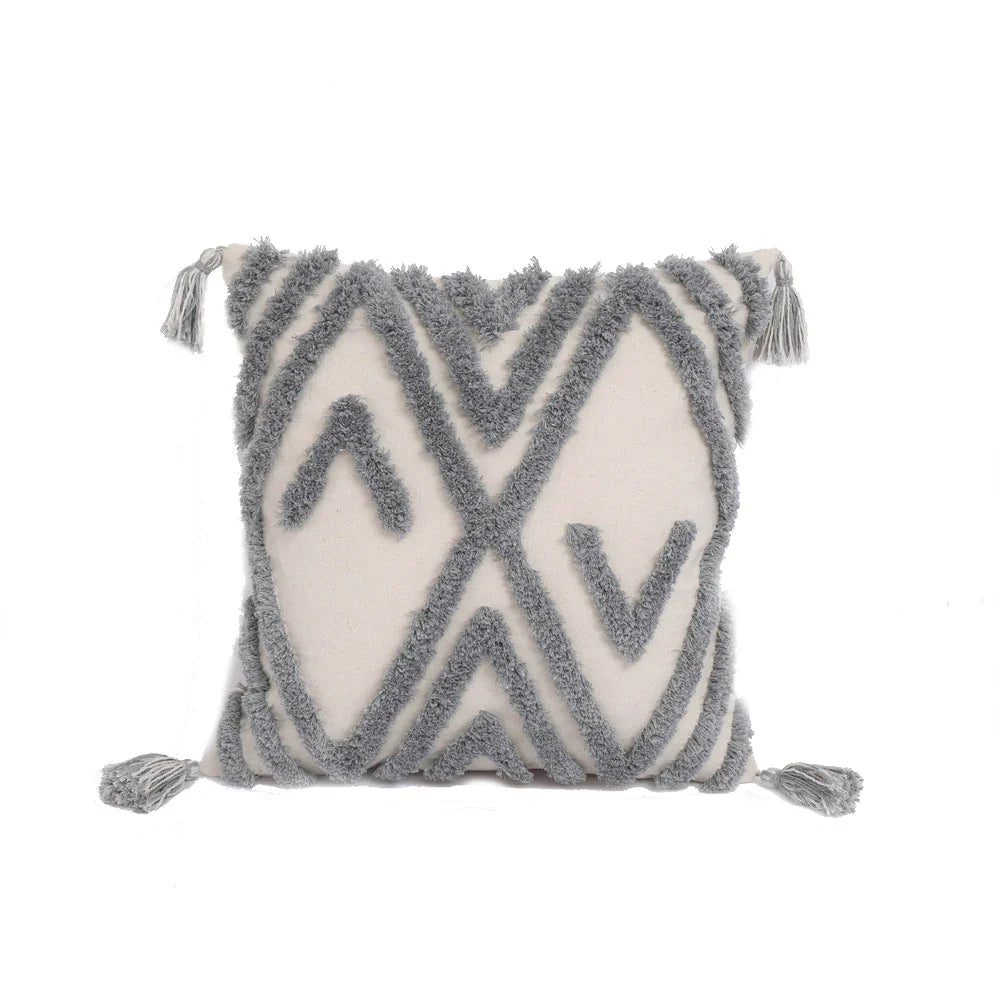 Moroccan style pillow case with intricate design and tassels, enhancing bedroom decor.