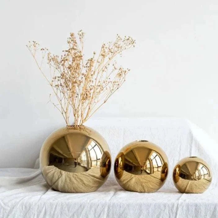 Nuala Vase in gold finish displayed in three sizes, stylish home decor accessory.