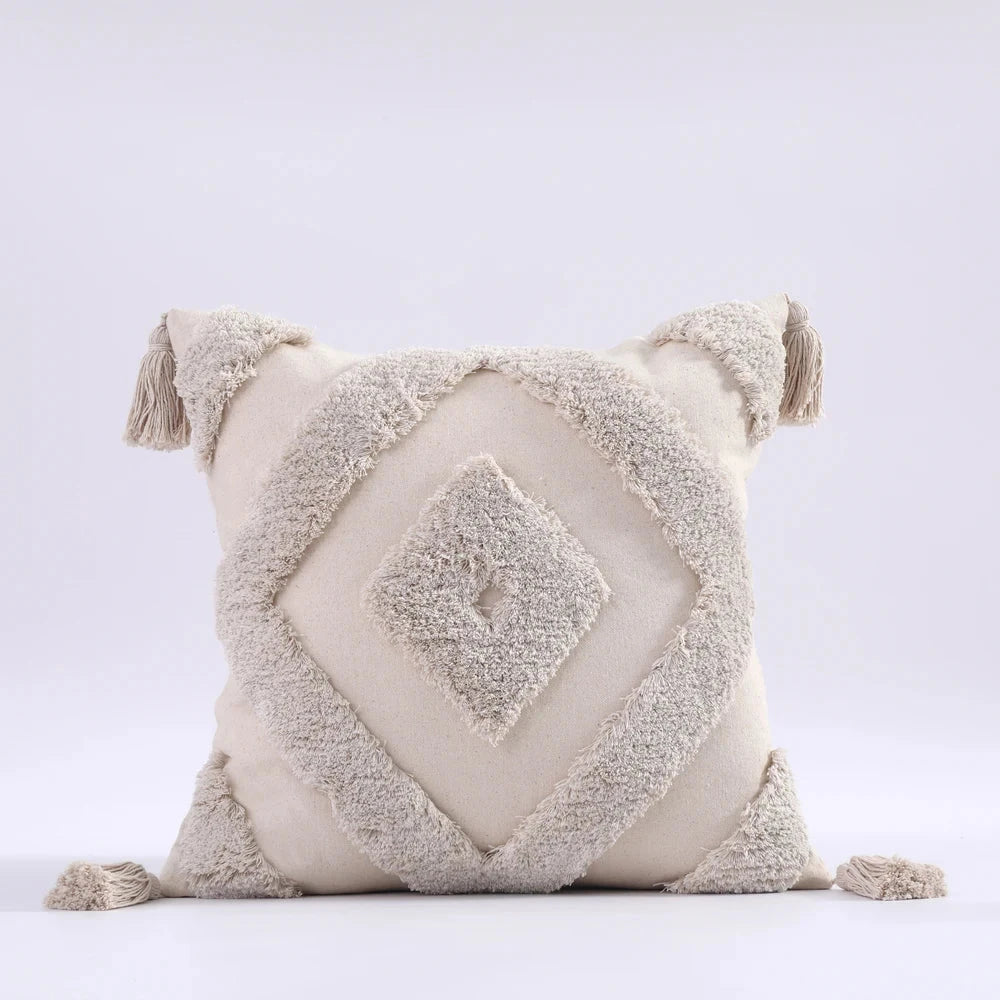 Moroccon style pillow case with intricate designs and tassels.
