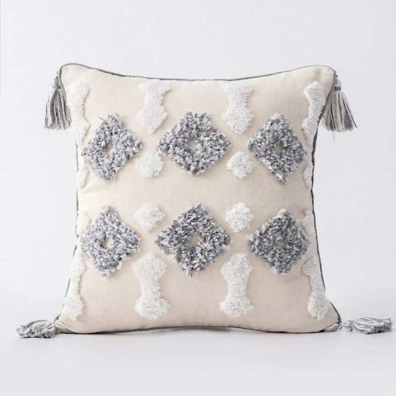 Moroccan style pillow case with intricate patterns and tassels, enhancing bedroom decor.