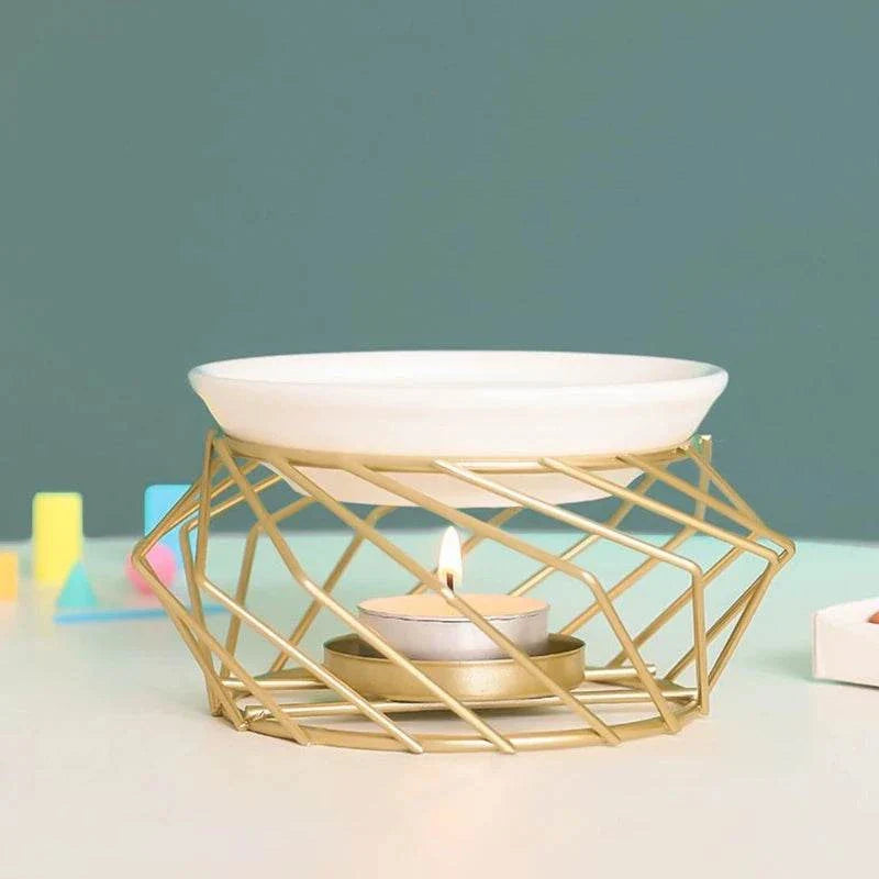 Aromatic Oil Burner with gold geometric design and tealight.