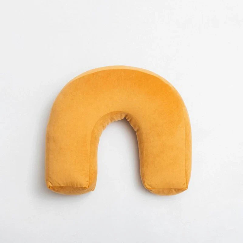 Playful Cyril Cushion with unique waves and knot design in yellow.