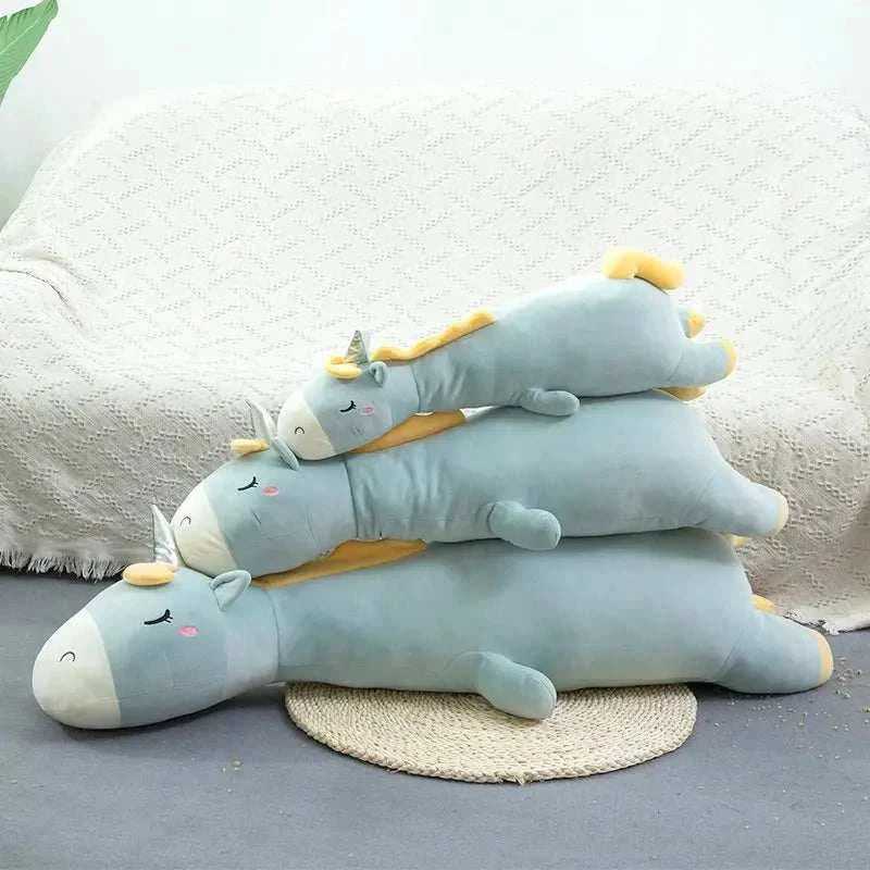Giant unicorn pillow in cozy living room setting.