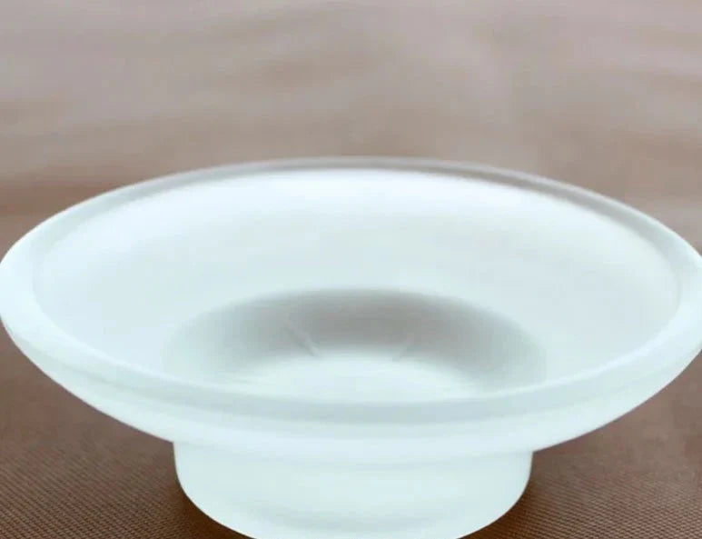Vishka glass soap dish on light surface, sleek and easy-to-clean design.