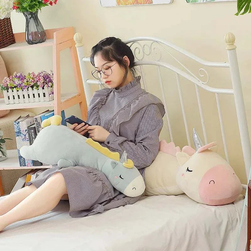 Giant unicorn pillow for kids on bed, ultra-soft and whimsical design.