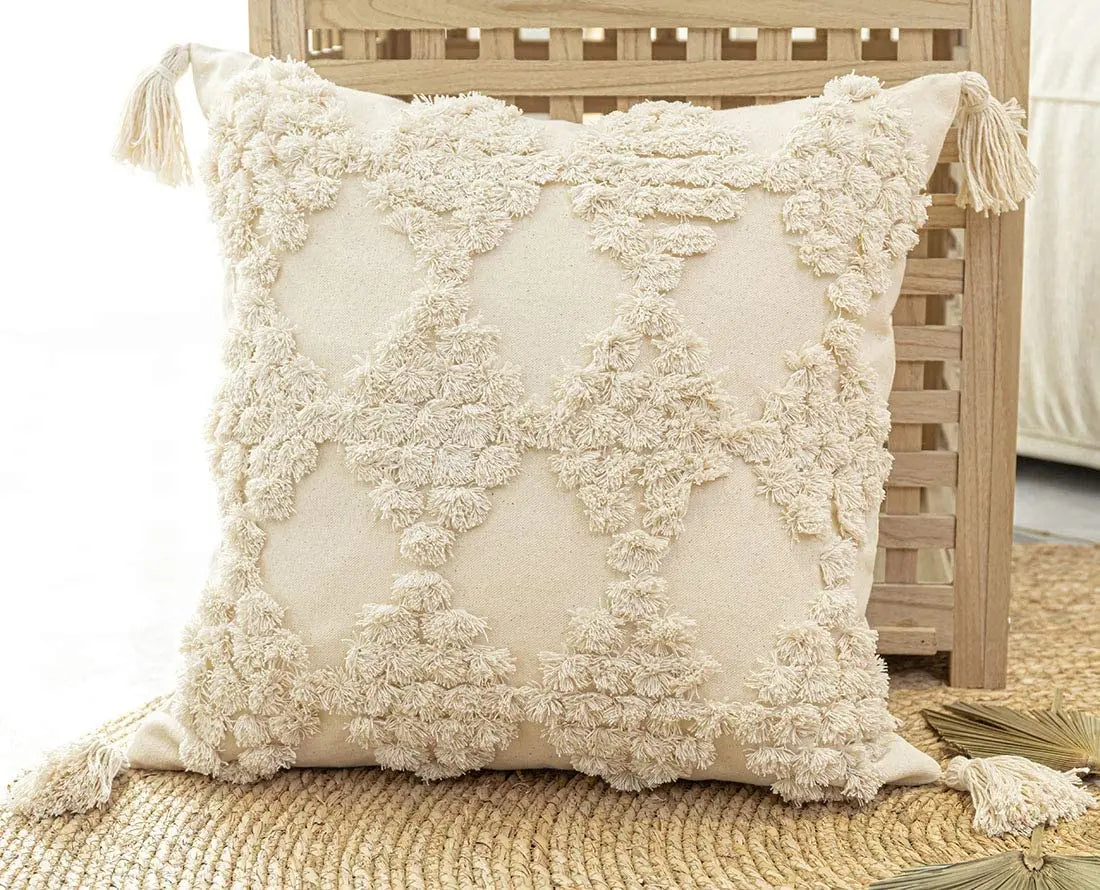 Moroccon style pillow case with intricate patterns and tassel design.