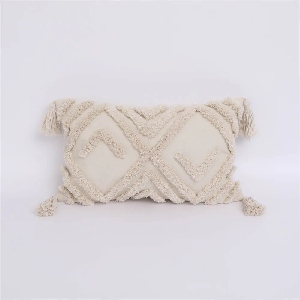 Moroccon style pillow case with intricate patterns and tassels.