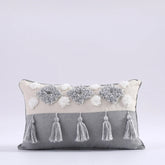Moroccon style pillow case with intricate patterns and tassels.