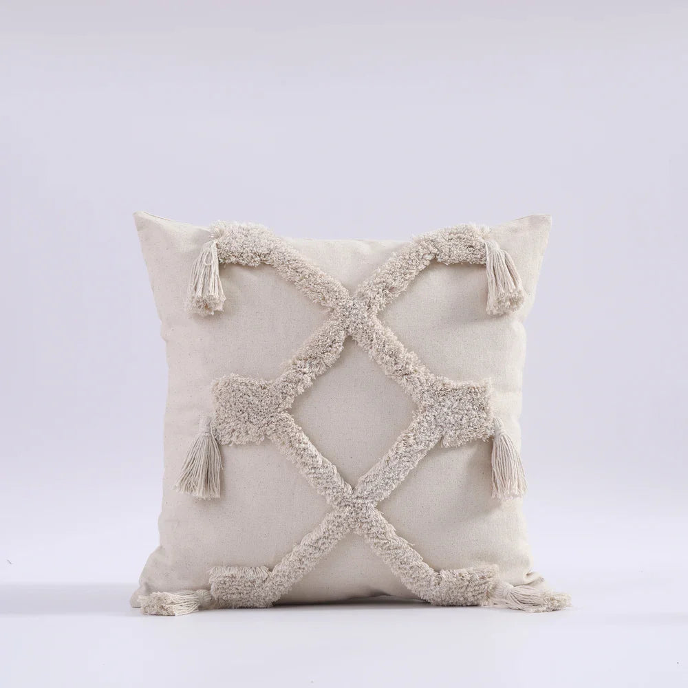 Moroccon style pillow case with intricate design and tassels.