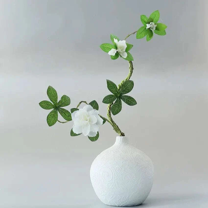Faux Azaleas Branch in decorative white vase.