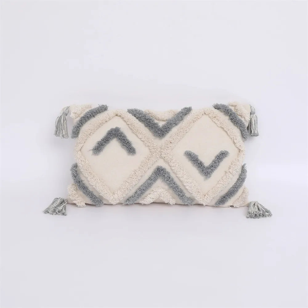 Moroccon style pillow case with intricate design and tassels.