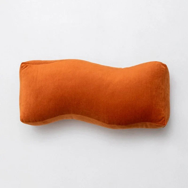 Cyril Cushions with playful waves and knot design in vibrant orange.