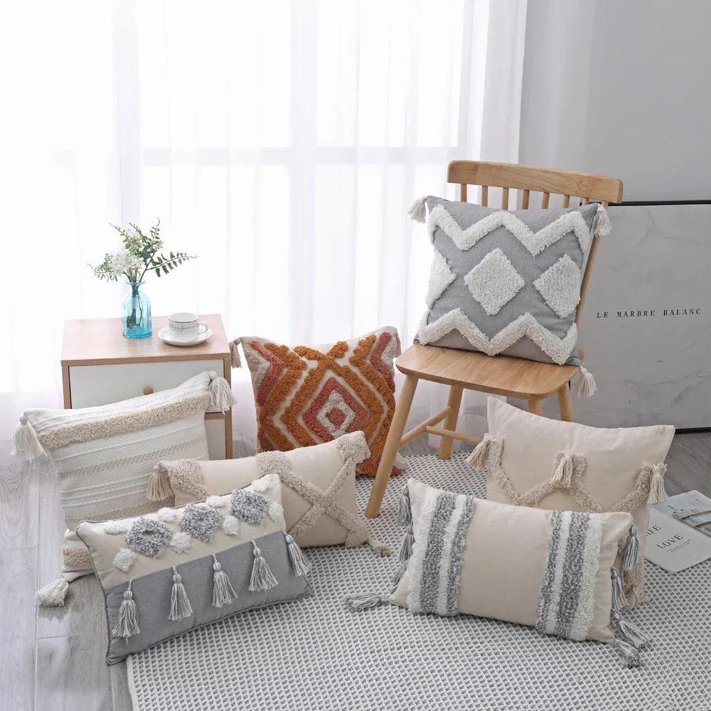 Moroccan style pillow cases with intricate patterns and tassels in a cozy bedroom setting.