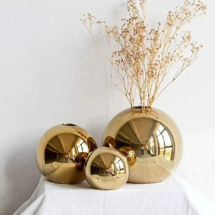 Gold spherical Nuala Vase enhancing home decor with sophistication.