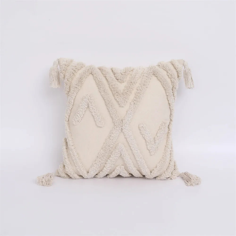 Moroccan style pillow case with intricate patterns and tassels.