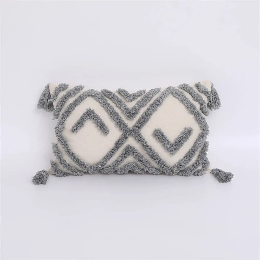Moroccon style pillow case with intricate gray and white geometric patterns.