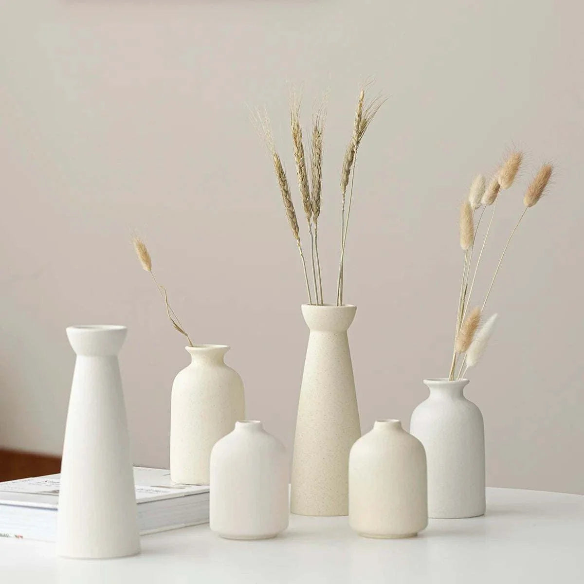 Minimalist cream ceramic Wulf Vases on display showcasing sleek, modern design.