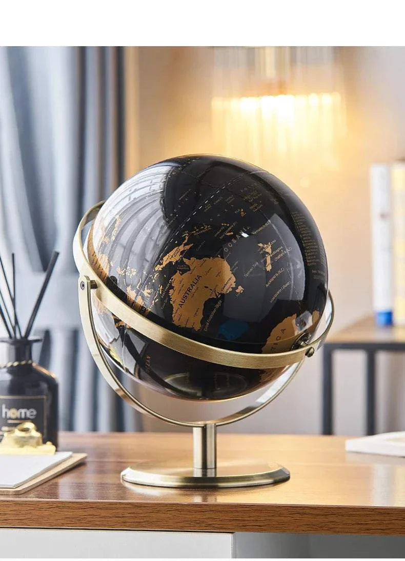 Aya Globes in black and gold on a desk, enhancing home or office decor with sophistication.