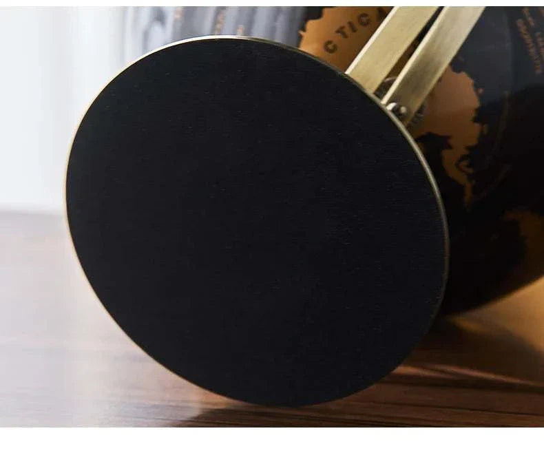 Aya Globes in black with sleek design on wooden surface.