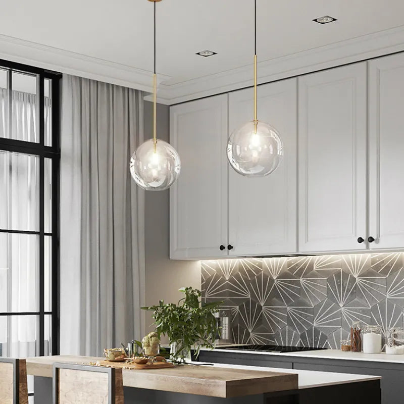 Anji lights hanging LED and glass ball design in modern kitchen.