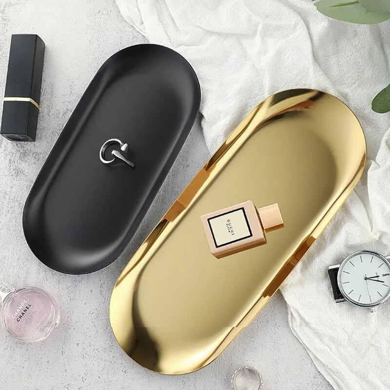Stainless Steel Oval Tray in gold and black displaying jewelry and perfume.