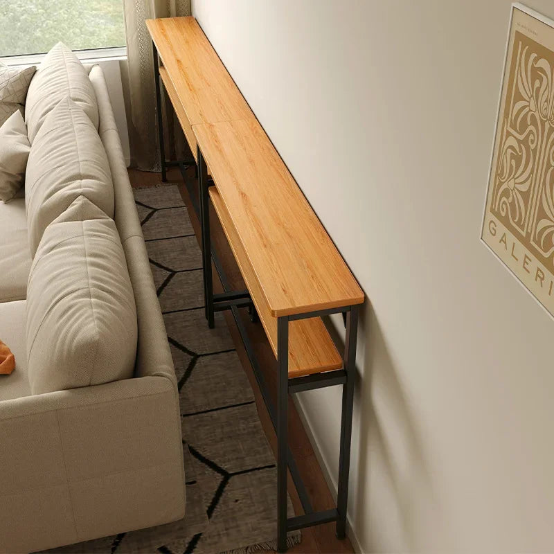 Slim and versatile Nawo table positioned behind a sofa with a sleek design and bold steel frame.
