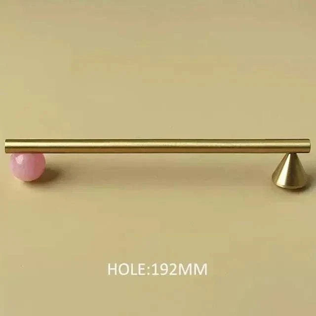 Natural crystal and brass furniture handle with pink decorative knob for kitchen cupboards and drawers.