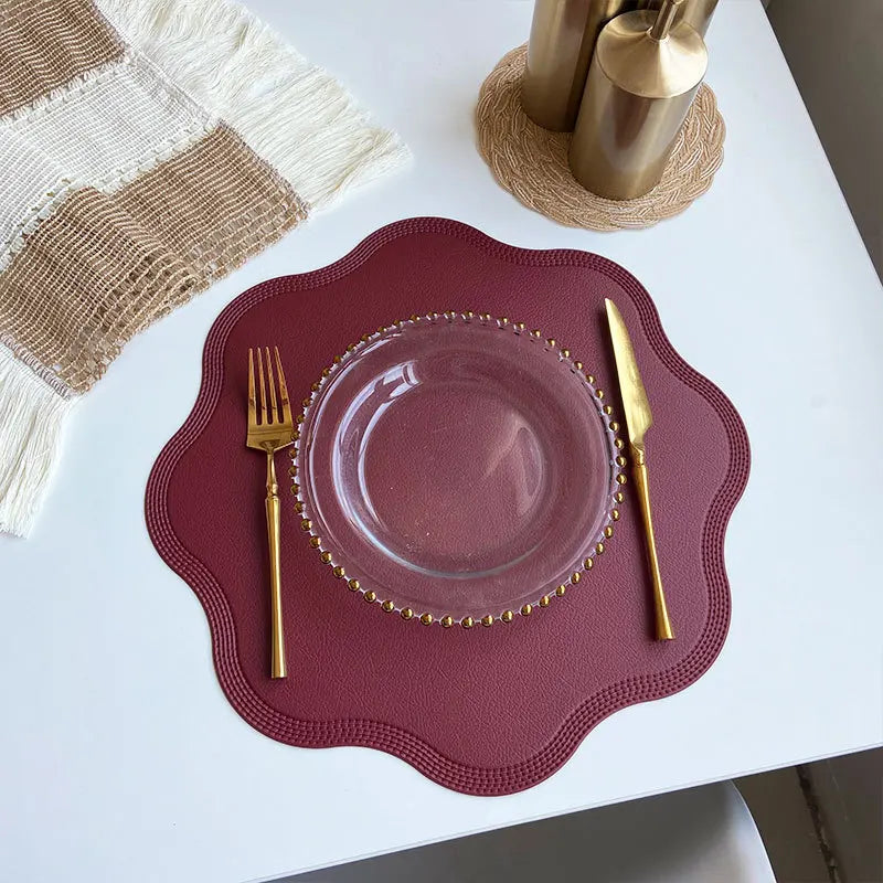 Noah's Placemats in elegant dining setting with gold cutlery and glass plate.