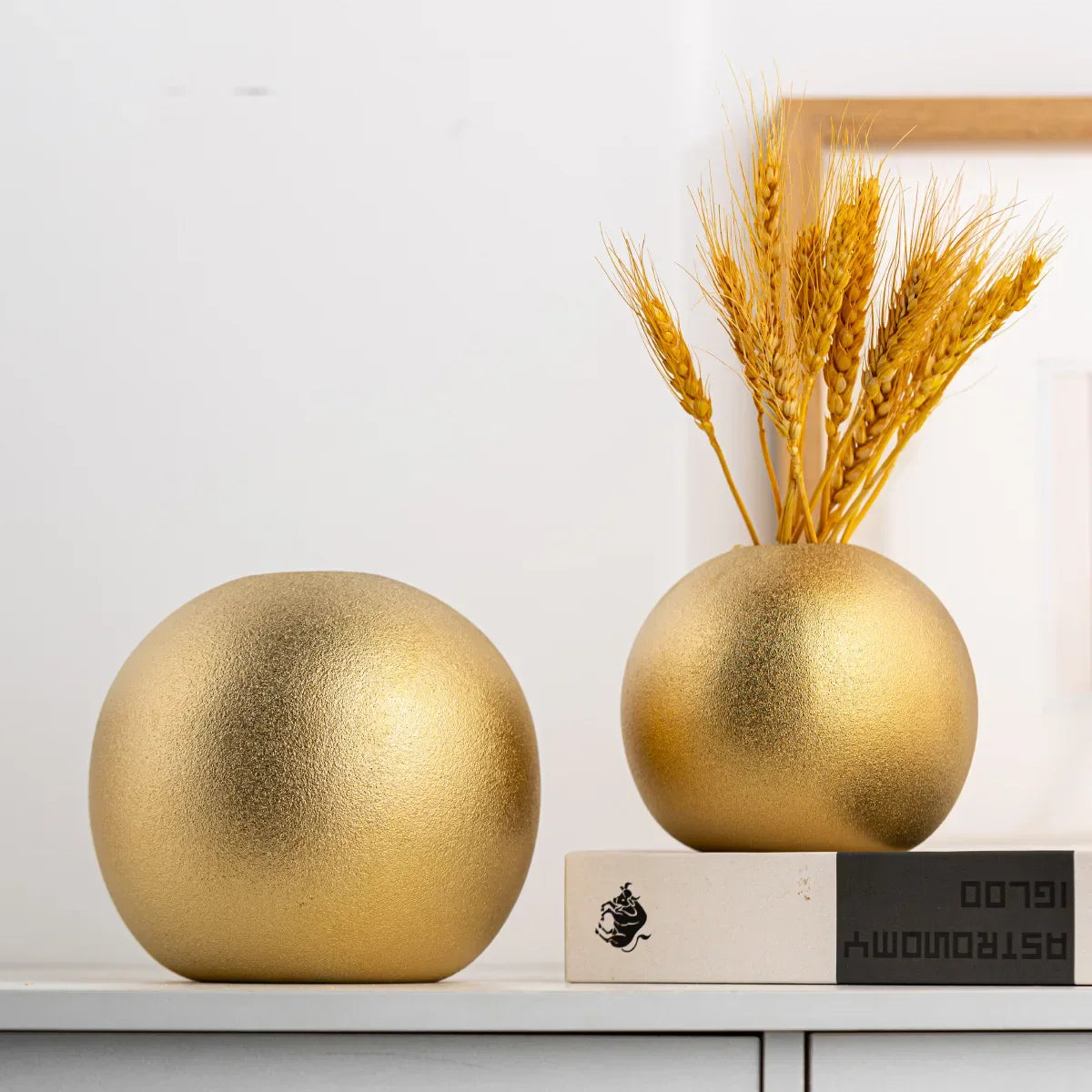 Nuala Ceramic Balls in gold with sleek design for vase or ornament use.