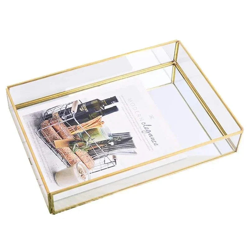 Orter trays with brass and glass in gold finish displaying an elegant magazine.