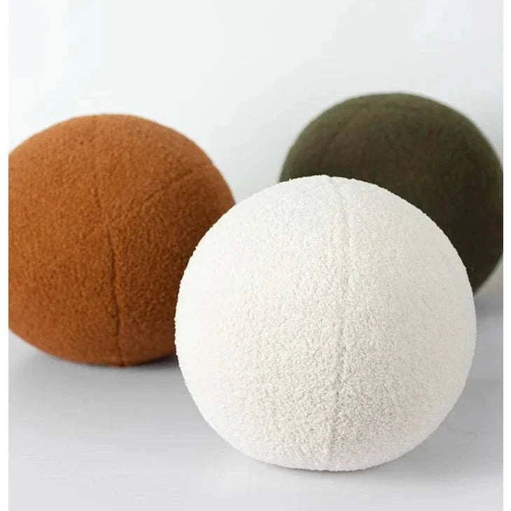 Soft round Bubble Kiss pillows in cozy autumn colors.