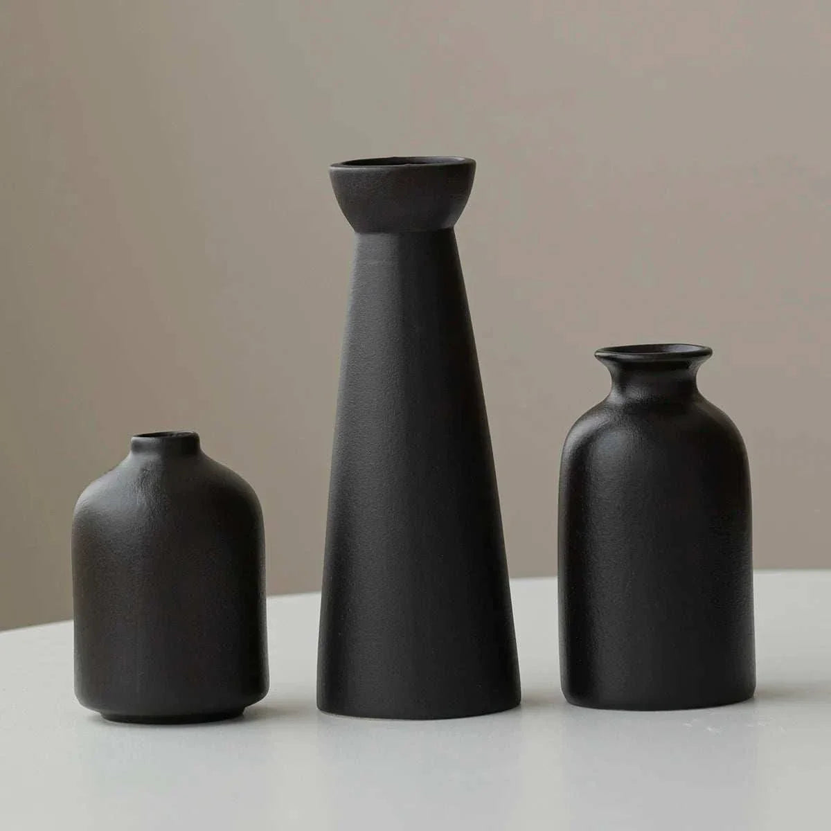 Wulf Vases in sleek cream ceramic with minimalist design.