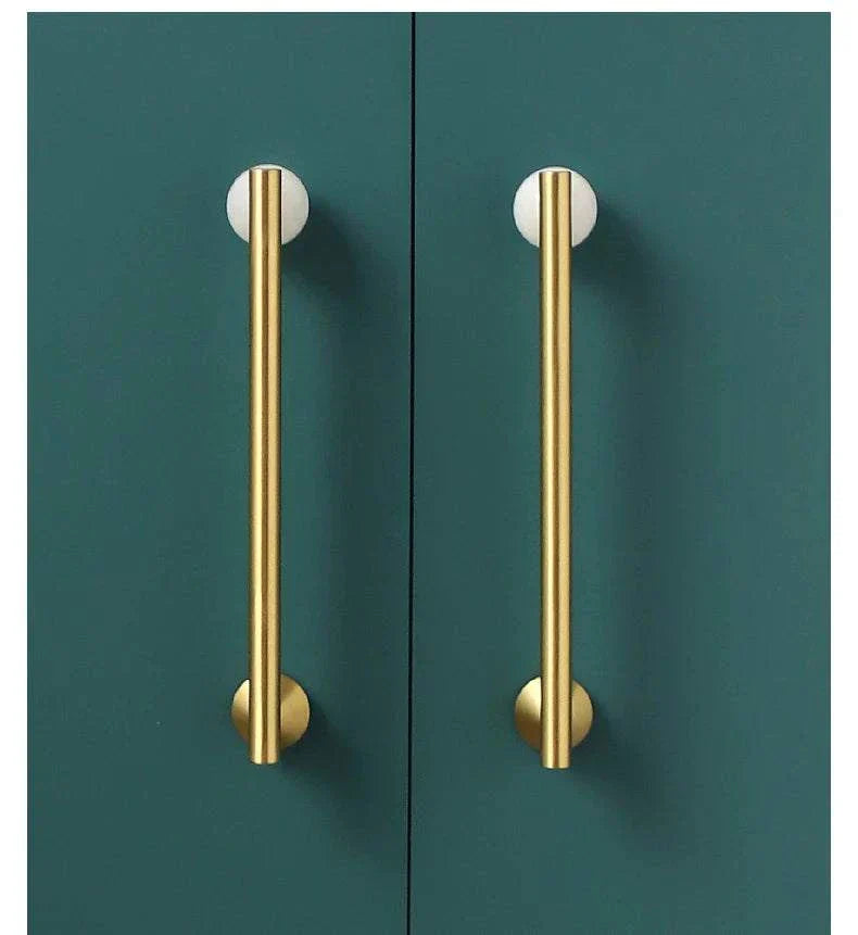 Natural Crystal + Brass Furniture Handles on green cupboards.