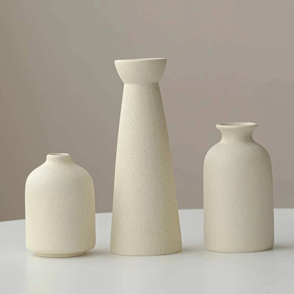 Sleek cream ceramic Wulf Vases with minimalist design for modern home decor.