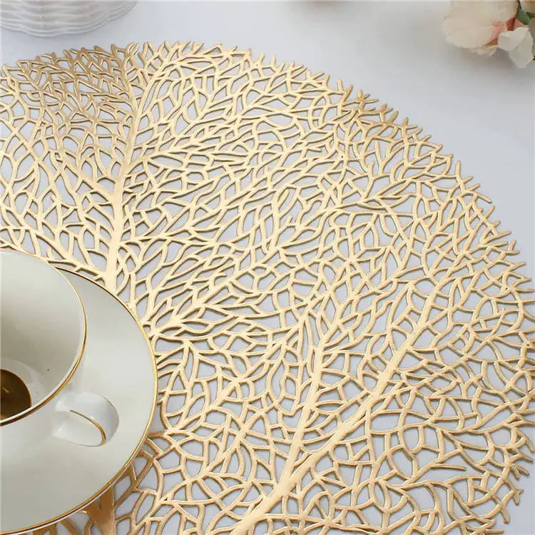 Ollie Placemats leaf design in golden PVC, modern table decor.