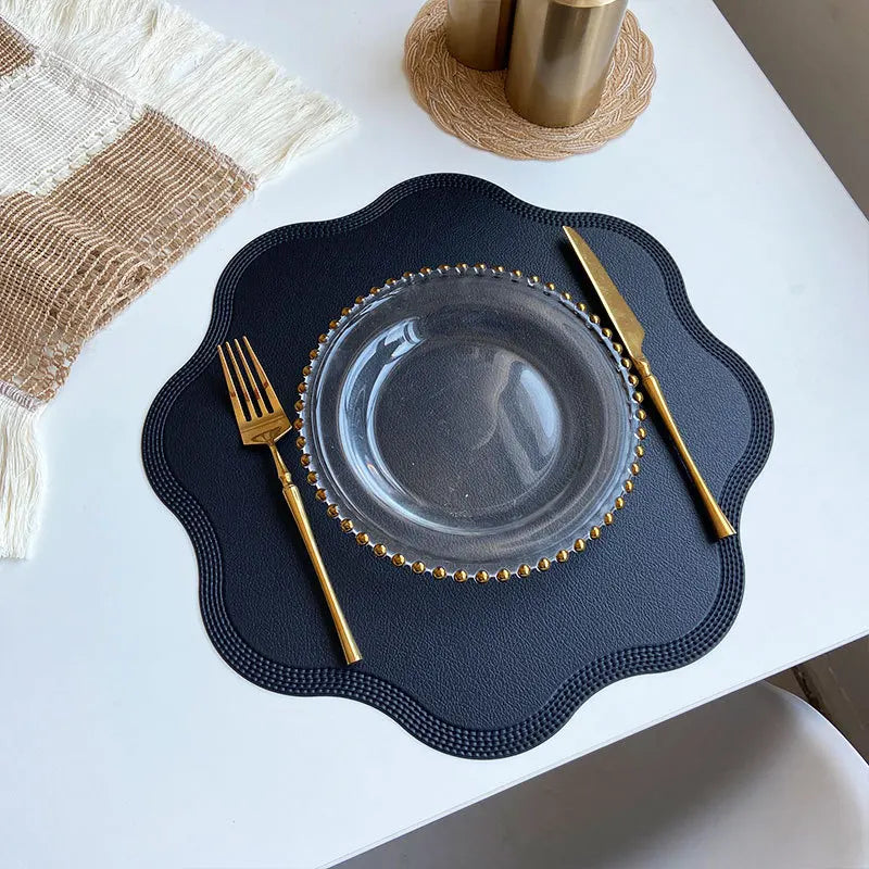 Noah’s Placemats set on a dining table with elegant gold cutlery and a glass plate.