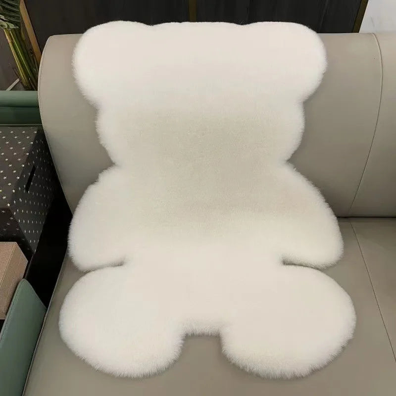 Matt the Bear Rug in faux fur on a sofa, adding warmth and playfulness to a child's bedroom.