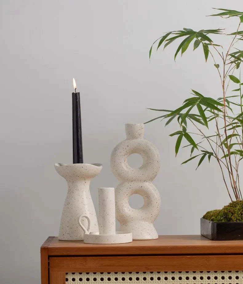 SUKi candle holders on a table, showcasing minimalist ceramic design.